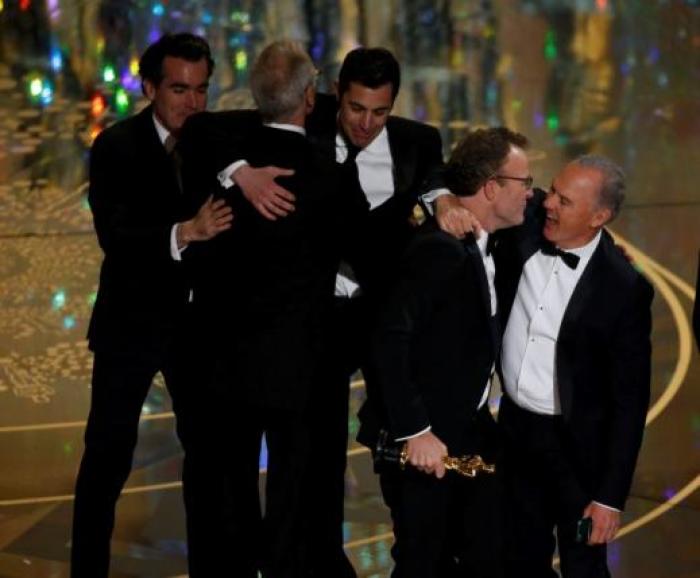 Actor Michael Keaton (R) hugs director Tom McCarthy after their film 'Spotlight' won the Oscar for Best Picture at the 88th Academy Awards in Hollywood, California February 28, 2016.
