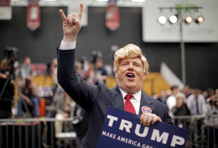 Supporter Forrest Surber dressed as U.S. Republican presidential candidate Donald Trump gestures before a campaign event in Radford, Virginia February 29, 2016.