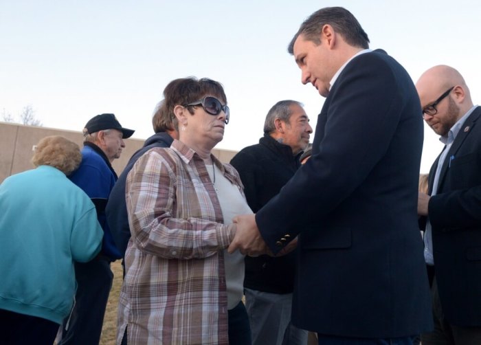 Republican U.S. presidential candidate Ted Cruz, making a Nevada Republican caucus night appearance, talks with Rachelle Clapp of Sparks, Nevada, about the problems she has had with the Affordable Care Act as she waited in line to caucus at Reed High School in Sparks, February 23, 2016.