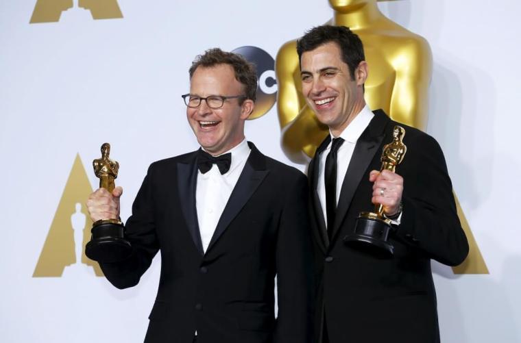 Tom McCarthy (L) and Josh Singer, winners of Best Original Screenplay for 'Spotlight', pose backstage at the 88th Academy Awards in Hollywood, California, February 28, 2016.
