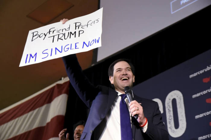 Republican U.S. presidential candidate Marco Rubio holds up a supporter's signage that reads 'Boyfriend prefers Trump I'm single now' at a campaign rally on the eve of Super Tuesday in Oklahoma City, Oklahoma February 29, 2016.