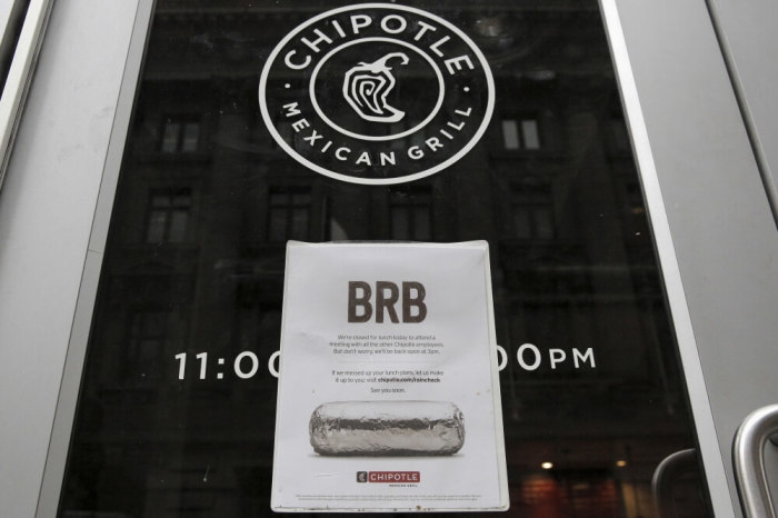 A sign is seen posted on the door of a Chipotle Mexican Grill in New York February 8, 2016.