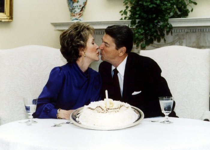 President Ronald Reagan and his wife Nancy kiss on their wedding anniversary in the White House, March 4 1985.
