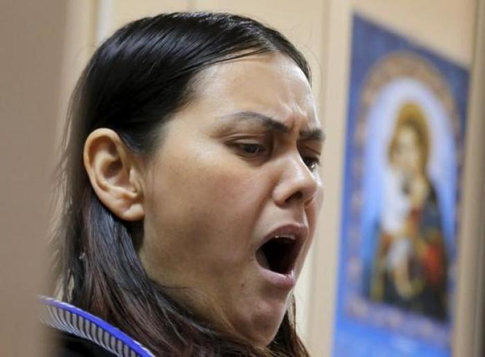 Gyulchekhra Bobokulova, a nanny suspected of murdering a child in her care, yawns inside a defendants' cage as she attends a court hearing in Moscow, Russia, March 2, 2016.