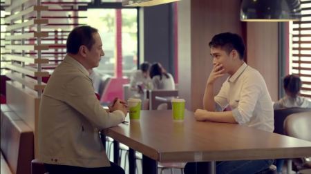 A minute-and-a-half McDonalds ad features a boy coming out to his father by writing, "I like boys" on a McCafe coffee cup and sliding it across the table, released March 4, 2016.
