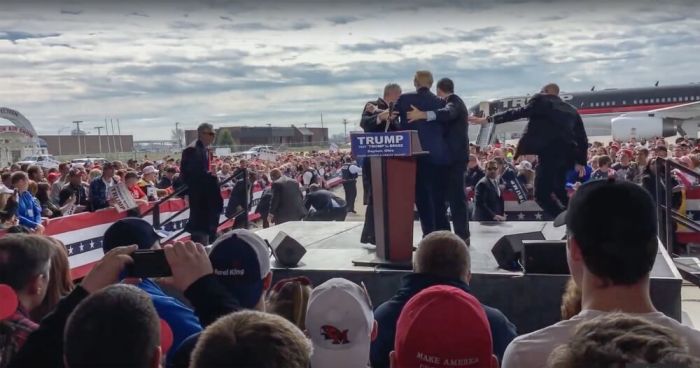 Secret Service agents surround Donald Trump after a man rushes toward him at a rally in Ohio