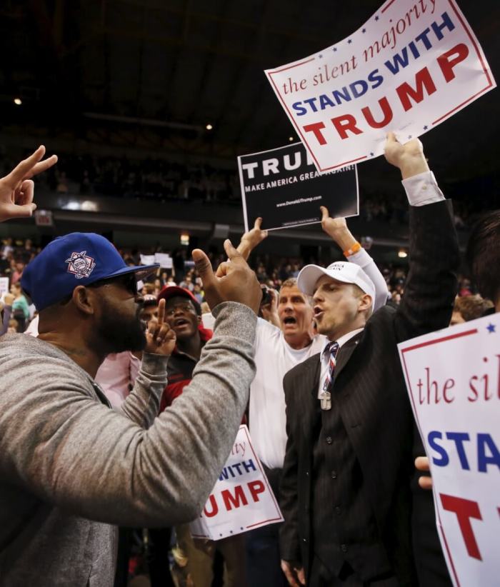 Trump supporter (R) exchanges words with a demonstrator (L) after Republican U.S. presidential candidate Donald Trump cancelled his rally at the University of Illinois at Chicago March 11, 2016.