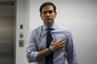 U.S. Senator and then Republican presidential candidate Marco Rubio holds his hand over his heart in a backstage area as the pledge of allegiance is recited before a campaign rally at Palm Beach Atlantic University in West Palm Beach, Florida, March 14, 2016.