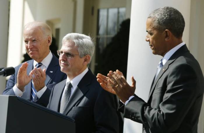 U.S. President Barack Obama applauds Judge Merrick Garland (C) of the United States Court of Appeals as his nominee for the U.S. Supreme Court as Vice President Joe Biden (L) joins in at the Rose Garden of the White House in Washington March 16, 2016.