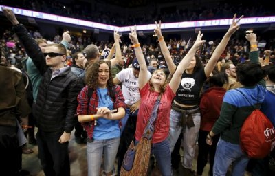 Demonstrators celebrate after Republican U.S. presidential candidate Donald Trump cancelled his rally at the University of Illinois at Chicago March 11, 2016.