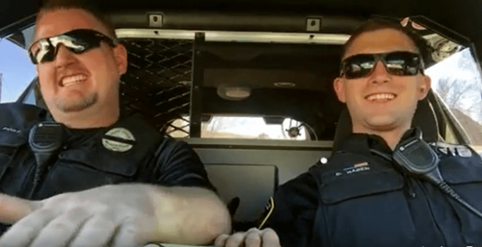 Two Colorado police singing along with the Journey ballad 'Don't Stop Believing.'