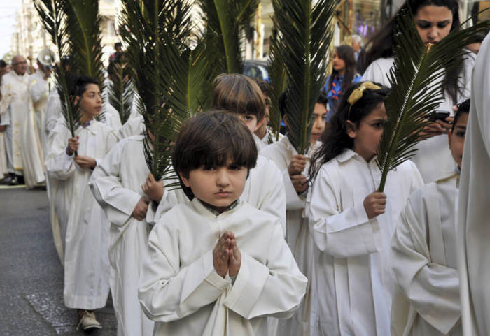 Christian Maronite children hold palm fronds during a Palm Sunday procession in the coastal city of Tripoli, northern Lebanon March 20, 2016.