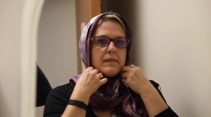 North Kansas City High School guidance counselor Martha DeVries fixes her hijab during this undated video posted to YouTube on March 18, 2016.