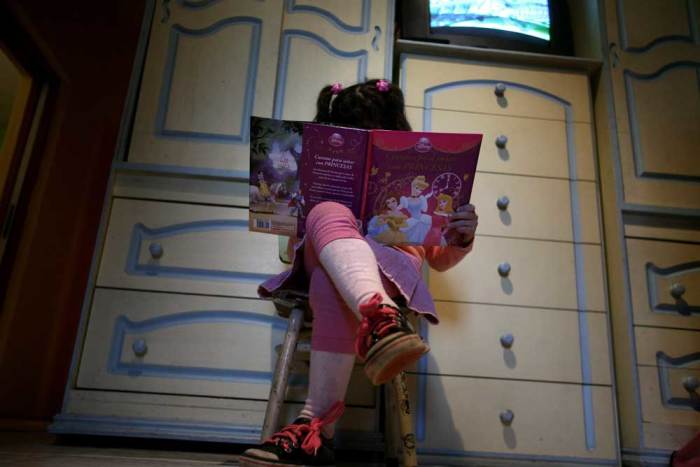 Lulu, a transgender girl, reads a book in her room at her home in Buenos Aires July 25, 2013. Lulu, a six-year-old Argentine child who was listed as a boy at birth, has been granted new identification papers by the Buenos Aires provincial government listing her as a girl. According to her mother Gabriela, Lulu chose the gender as soon as she first learned to speak. Gabriela said her child, named Manuel at birth, insisted on being called Lulu since she was just four years old, local media reported. Argentina in 2012 put in place liberal rules on changing gender, allowing people to alter their gender on official documents without first having to receive a psychiatric diagnosis or surgery. Picture taken on July 25, 2013.