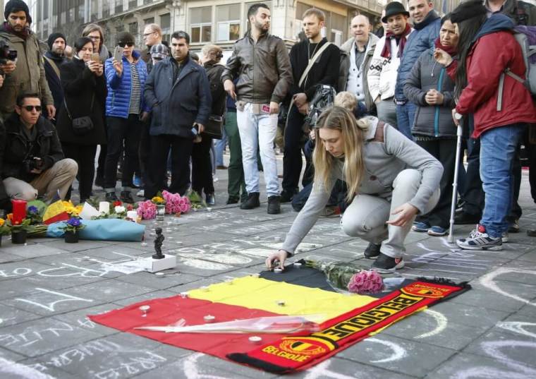 People gather around a memorial in Brussels following bomb attacks in Brussels, Belgium, March 22, 2016.