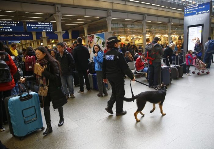 A police dog handler patrols after Eurostar trains to Brussels were cancelled at St Pancras station in central London, Britain, March 22, 2016.
