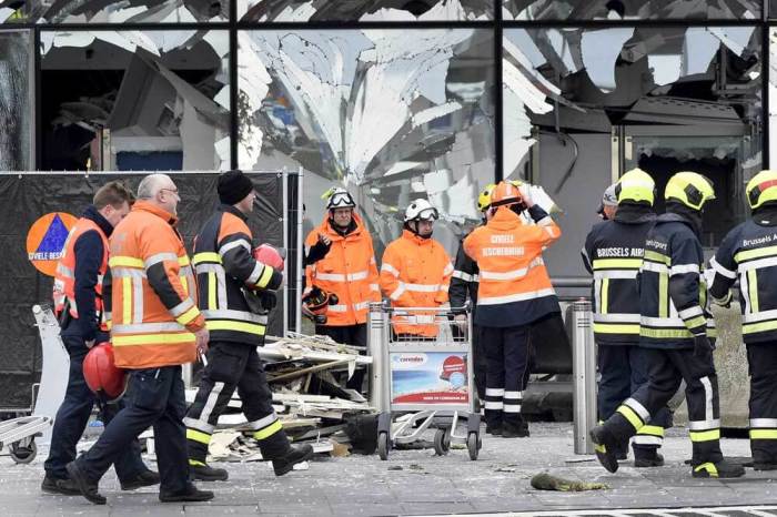 Broken windows of the terminal at Brussels airport are seen during a ceremony following bomb attacks in Brussels in Zaventem, Belgium, March 23, 2016.