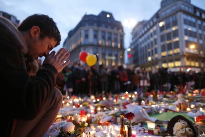 A man attends a memorial gathering near the old stock exchange in Brussels following Tuesday's bomb attacks in Brussels, Belgium, March 23, 2016.