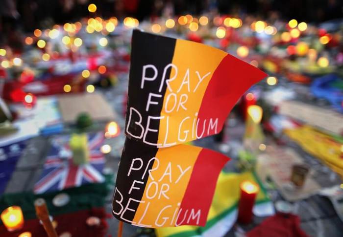 Belgian flags seen at a street memorial service near the old stock exchange in Brussels following Tuesday's bomb attacks in Brussels, Belgium, March 23, 2016.