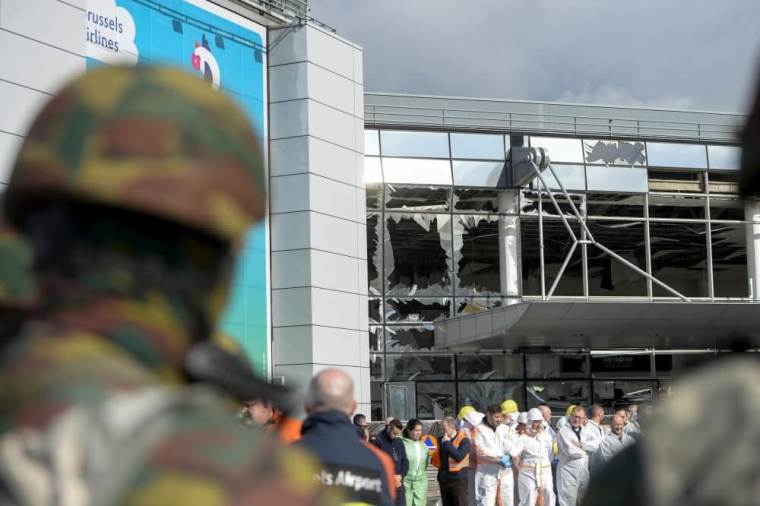 Windows of the terminal at Brussels national airport are seen broken during a ceremony following bomb attacks in Brussels metro and Belgium's National airport of Zaventem, Belgium, March 23, 2016.