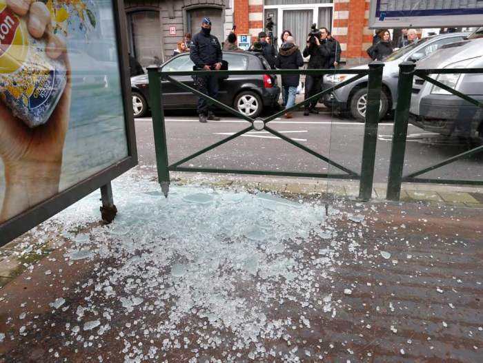 Broken glass from a tramway stop shelter is seen after shots were fired during a police search in the Brussels borough of Schaerbeek, Belgium, March 25, 2016.