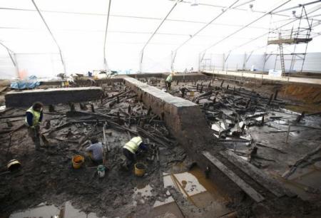 Archaeologists from the University of Cambridge Archaeological Unit, uncover Bronze Age wooden houses, preserved in silt, from a quarry near Peterborough, Britain, January 12, 2016.