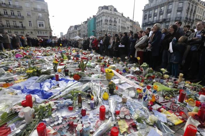 People gather at a street memorial in Brussels following Tuesday's bombings in Brussels, Belgium, March 25, 2016.