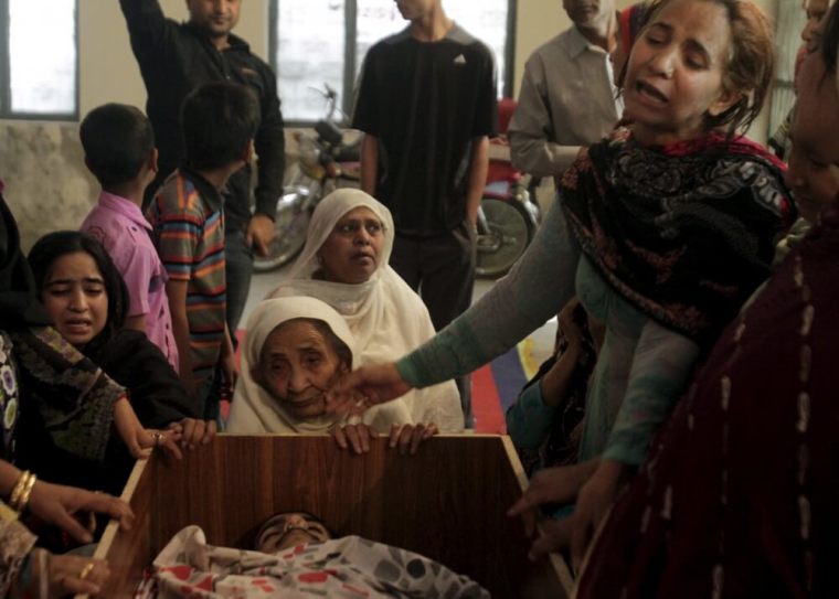 Family members mourn the death of a relative, who was killed in a blast outside a public park on Sunday in Lahore, Pakistan, March 28, 2016.