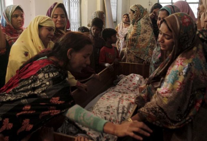 Family members mourn the death of a relative, who was killed in a blast that happened outside a public park on Sunday, in Lahore, Pakistan, March 28, 2016.
