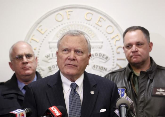 Georgia Governor Nathan Deal (C), speaks to the media as Public Safety Director Mark McDonough (L), and Georgia National Guard Director General Jim Butterworth listen at the State Capitol in Atlanta, Georgia, January 30, 2014