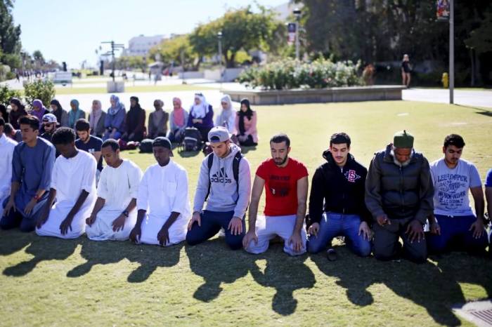 Muslim students hold a prayer before a rally against Islamophobia at San Diego State University in San Diego, California, November 23, 2015.
