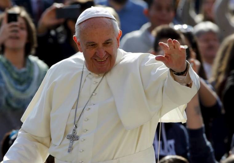 Pope Francis waves as he arrives to lead his weekly general audience in Saint Peter's Square at the Vatican March 30, 2016.