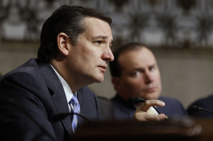 U.S. Senator Ted Cruz (R-TX) (L) questions Ashton Carter (not pictured), U.S. President Barack Obama's nominee to be secretary of defense, during a Senate Armed Services Committee confirmation hearing on Capitol Hill in Washington, February 4, 2015. Also pictured at right is Senator Mike Lee (R-UT).