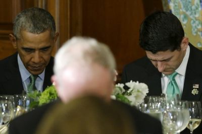 U.S. President Barack Obama (L-R) and House Speaker Paul Ryan bow their heads in prayer at the annual Friends of Ireland Luncheon at the U.S. Capitol in Washington March 15, 2016.
