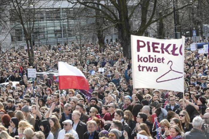 People demonstrate against the Polish government's plan of tightening the abortion law in front of the Parliament in Warsaw, Poland April 3, 2016. Banner reads: 'Hell of women continues'.