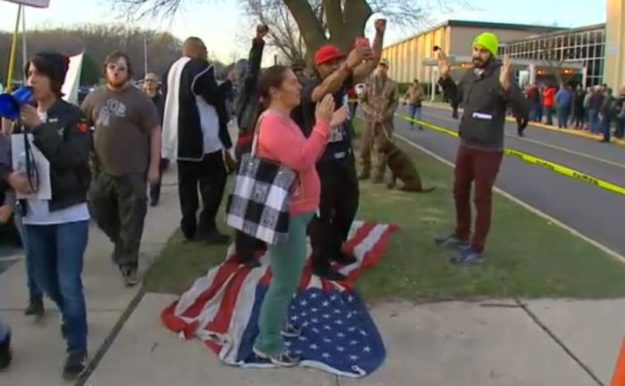 Protesters trample American flag outside Trump rally in West Allis, Wis., on April 3, 2016.