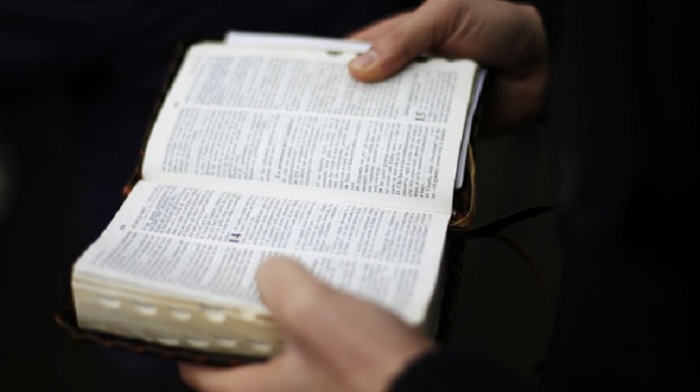 A man reads the Holy Bible.