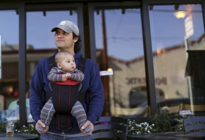 Steve Caniglia holds his six-month-old son, Boden, in San Francisco, California February 19, 2014.