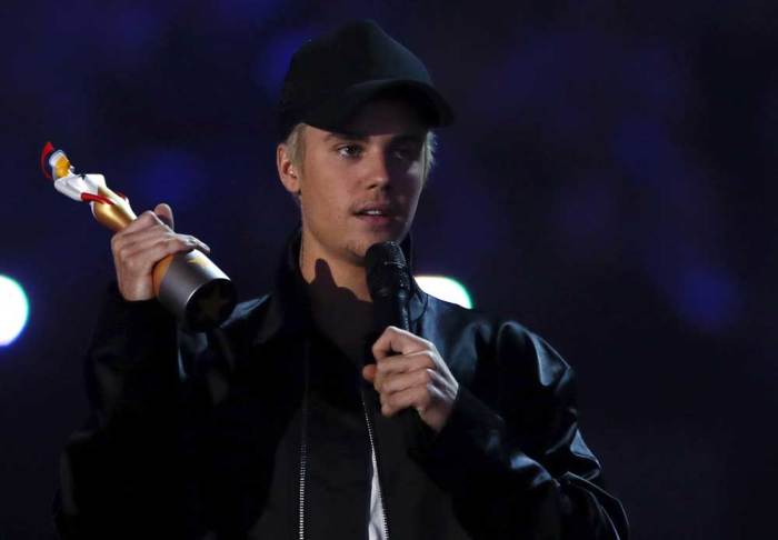 Justin Bieber accepts the award for best international male artist at the BRIT Awards at the O2 arena in London, February 24, 2016.