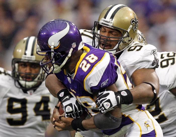 New Orleans Saints defensive end Will Smith (91) holds back Minnesota Vikings running back Adrian Peterson (28) for a loss of five yards during the second half of their NFL football game in Minneapolis, Minnesota, December 18, 2011.