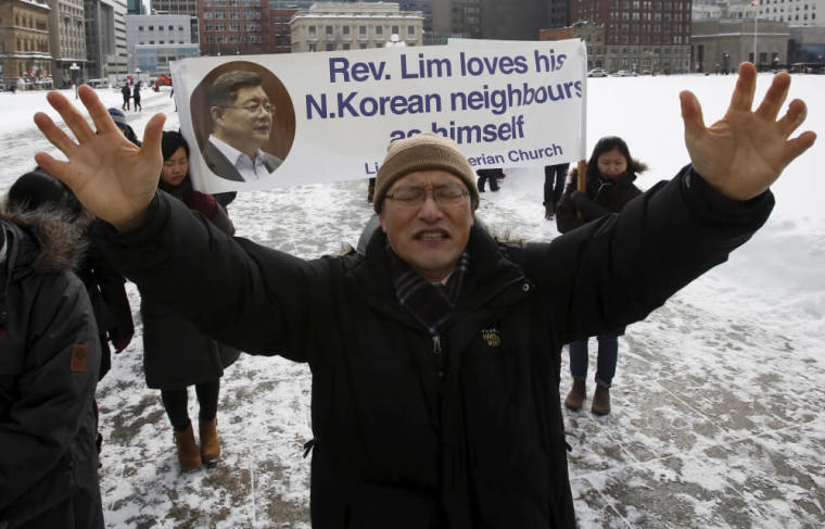 A man prays during a demonstration for Canadian Pastor Hyeon Soo Lim, who is being held in North Korea, on Parliament Hill in Ottawa, Canada, February 17, 2016.