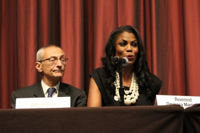 John Podesta (L) chairman of Hillary Clinton's 2016 presidential campaign listens as Rev. Omarosa Manigault (R) addresses the National Action Network convention in New York City on Wednesday April 13, 2016.
