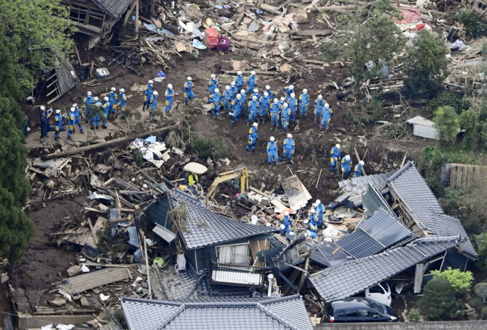 Rescue workers conduct a search and rescue operation to a collapsed house at a landslide site caused by earthquakes in Minamiaso town, Kumamoto prefecture, southern Japan, in this photo taken by Kyodo April 16, 2016.