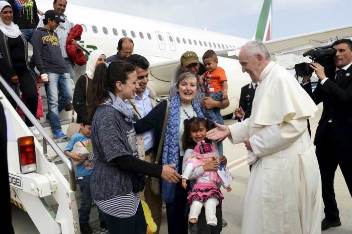Pope Francis welcomes a group of Syrian refugees after landing at Ciampino airport in Rome following a visit at the Moria refugee camp in the Greek island of Lesbos, April 16, 2016.