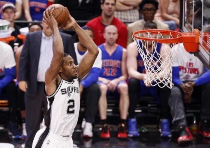 San Antonio Spurs defensive expert Kawhi Leonard dunks the ball in a game against the Detroit Pistons at AT&T Center.