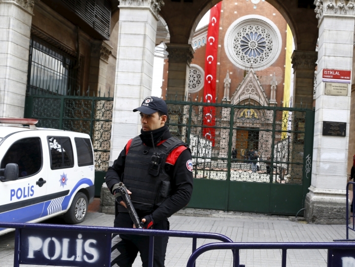 A Turkish police officer stands guard in front of St Antouan Church at Istiklal Street in Istanbul, Turkey, March 27, 2016.