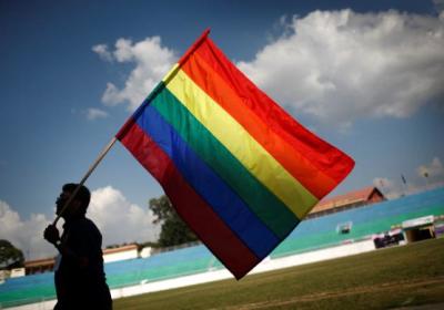 A man is shown here holding on to a flag representing the LGBT community during the South Asia Lesbian, Gay, Bisexual, and Transgender Sports Fest in Kathmandu, Nepal.