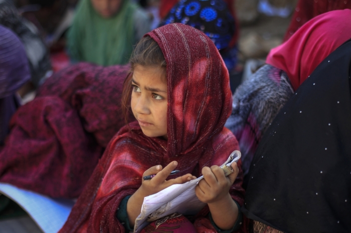 A girl attends a class at a makeshift school on the outskirts of Islamabad, Pakistan, April 7, 2014.