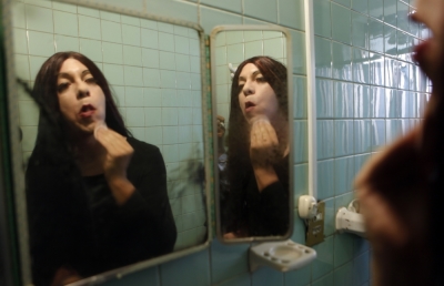 Claudio Vargas, 40, also known as Anxelica Risco, an LGBT activist, touches up his make up while in the bathroom at his office in Mexico City, Mexico, June 18, 2009.