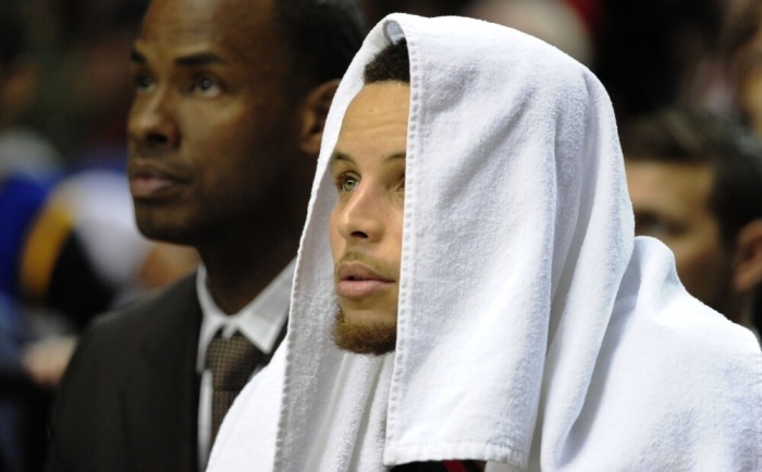 Golden State Warriors guard Stephen Curry (30) looks on from the bench during the fourth quarter of the game against the Portland Trail Blazers at the Moda Center at the Rose Quarter on Feb 19, 2016 in Portland, Oregon.